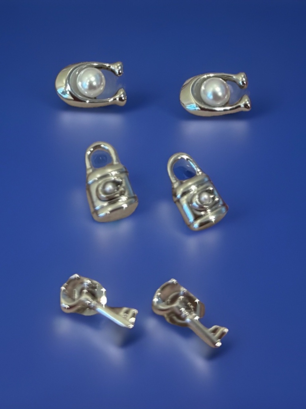 COACH | Set of 3 Pairs Silver Metal Stud Earrings - Key, Padlock, Horseshoe/ ‘C’